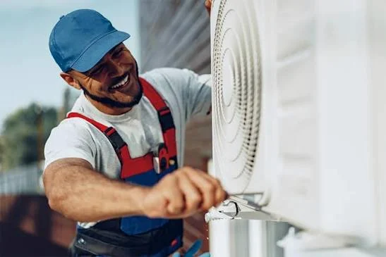 HVAC technician servicing a residential outdoor air conditioning unit