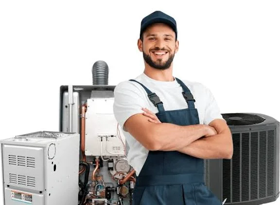 HVAC service technician standing beside residential heating and cooling equipment
